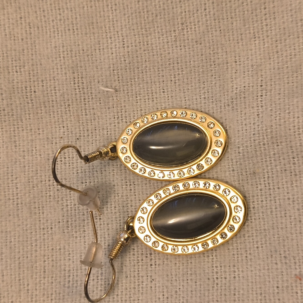 Earrings with charcoal color cats eye center.